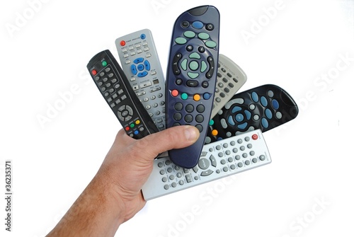 Photo: man hand holds six remote control, isolated on white man hand holds six remote control, isolated on white