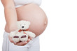 Pregnant woman hold in hand white toy bear