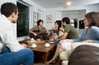 man playing guitar for friends man playing guitar for friends