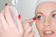 Woman plucking eyebrow Woman plucking eyebrow
