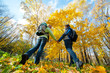 Happy young couple with backpacks in the park