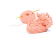 pink crocheted babby's bootees and thread with crochet