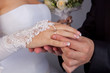 The groom puts on a ring a hand to the bride