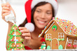 Christmas girl making gingerbread house