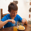 tanned caucasian boy eating a portion of tortilla in a cafe