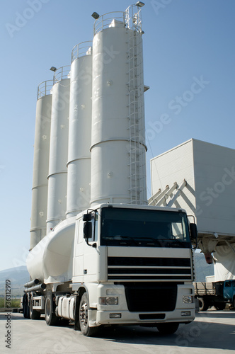 Photo: Cement factory with silos and mixer truck Cement factory with silos and mixer truck