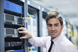young it engineer in datacenter server room young it engineer in datacenter server room