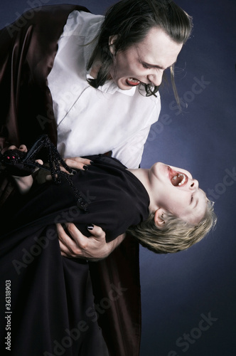 Photo: Adult vampire and his young victim Adult vampire and his young victim