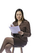 Female holding phone and sheet of paper