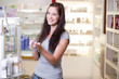 Beautiful young woman buying perfume. Shallow DOF.