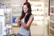 Happy young woman buying a perfume. Shallow DOF.