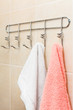 Two terry towels hanging on a hook in bathroom