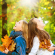 Beautiful Teenage Girls having fun in Autumn Park. Outdoor Beautiful Teenage Girls having fun in Autumn Park. Outdoor