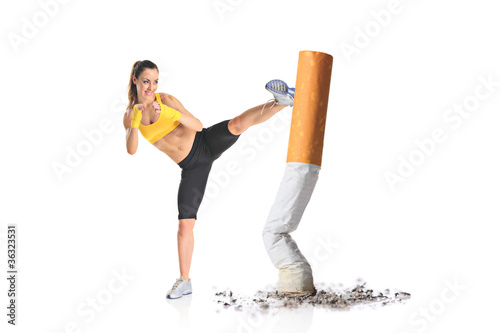 Photo: Girl kicking a cigarette butt Girl kicking a cigarette butt