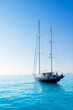 anchored sailboats in turquoise Formentera beach