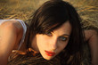 Photo: Portrait at the sunset: beautiful young girl lying on grass Portrait at the sunset: beautiful young girl lying on grass