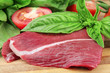 Piece of fresh meat from basilicas and a tomato