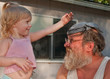 Toddler Girl Playing Dress Up with Grandpa
