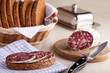 Served kitchen table, sandwich on napkin, salami, breadbasket, s