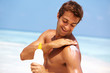 Man applying anti tanning lotion
