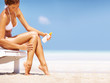 Woman applying suntan lotion