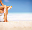 Woman applying lotion on legs Woman applying lotion on legs