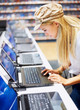 Arrtractive woman in store looking at laptop