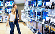 Young people checking out new television sets in megastore