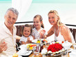 Happy family having exotic beach dinner