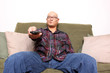 Asian man with remote watching television.
