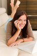 Modern living room woman lying sofa laptop