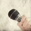 hand holding microphone - picture in retro style hand holding microphone - picture in retro style