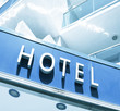 Hotel sign over light blue modern facade