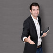 Salesman with tablet giving handshake