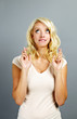 Hopeful woman crossing fingers