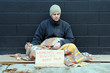Photo: Young homeless man begs on sidewalk Young homeless man begs on sidewalk