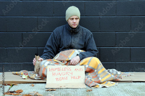 Photo: Young homeless man begs on sidewalk Young homeless man begs on sidewalk