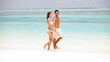 Video: Portrait of carefree couple enjoying while walking on seashore Portrait of carefree couple enjoying while walking on seashore