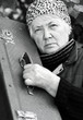 Elderly woman with old suitcase