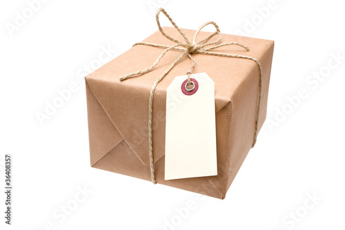 Photo: brown paper parcel with a blank luggage tag brown paper parcel with a blank luggage tag