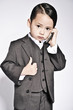baby boy in suit on cellphone