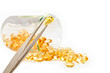 Inspection of gold pills against a white background Inspection of gold pills against a white background
