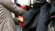 Woman chooses clothes in shop