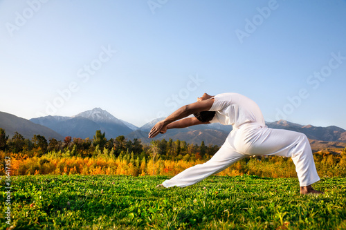 Photo: Yoga warrior pose in mountains Yoga warrior pose in mountains