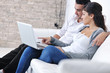 joyful couple relax and work on laptop computer at modern home