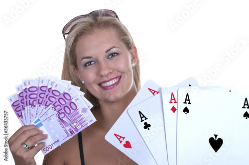 Photo: Blond Female model smiling while holding a poker hand of four ac Blond Female model smiling while holding a poker hand of four ac