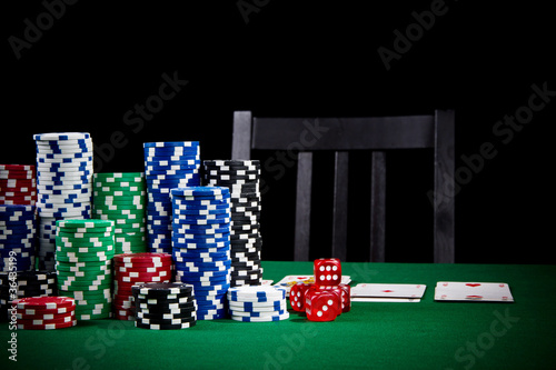Photo: Poker game with empty chair Poker game with empty chair