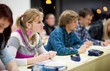 pretty, female college student sitting in a classroom