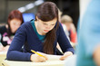 Photo: pretty, female college student sitting in a classroom pretty, female college student sitting in a classroom