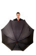 Young businessman with an umbrella on white background
